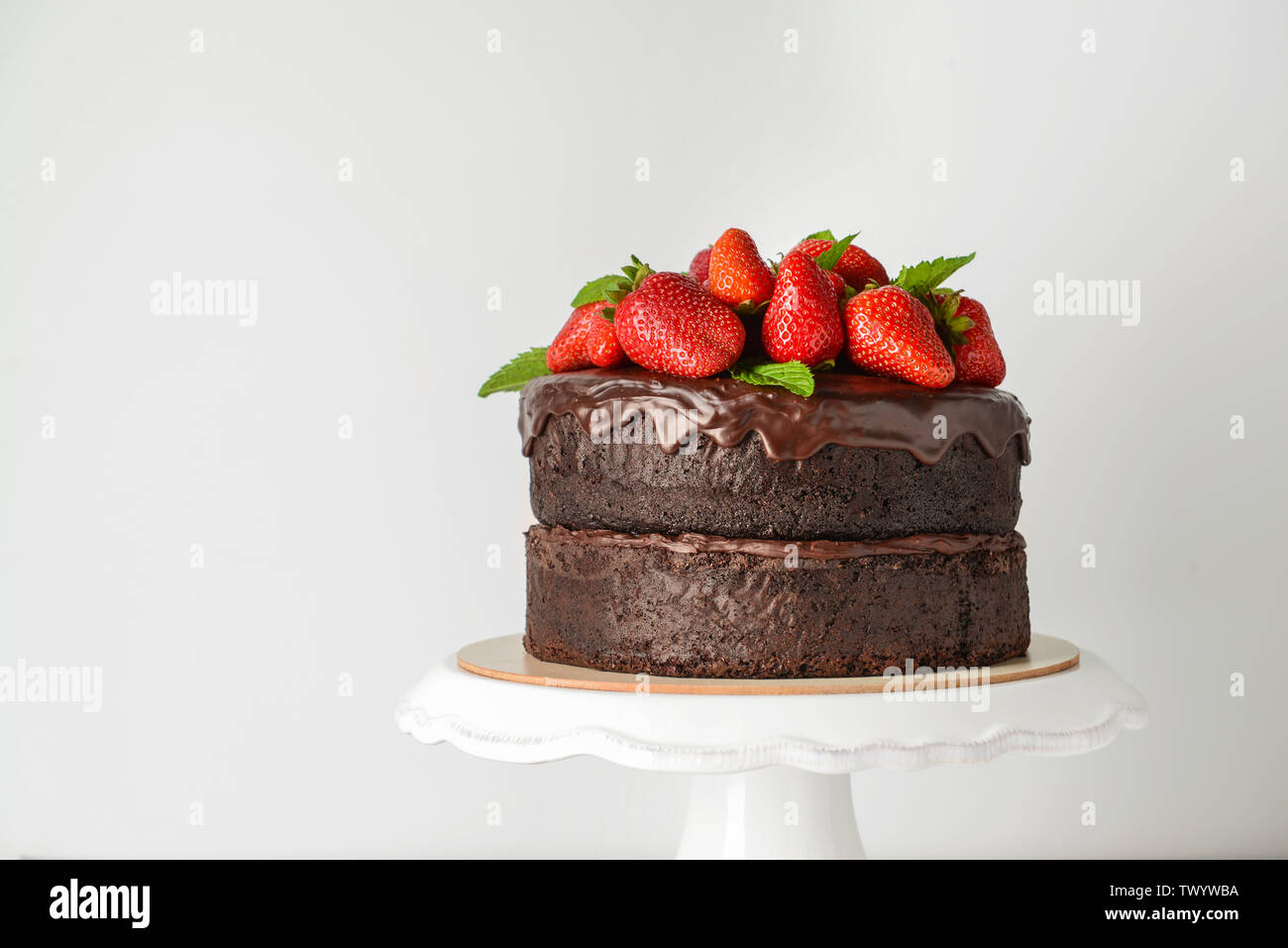Tasty chocolate cake with strawberry on white background Stock Photo ...