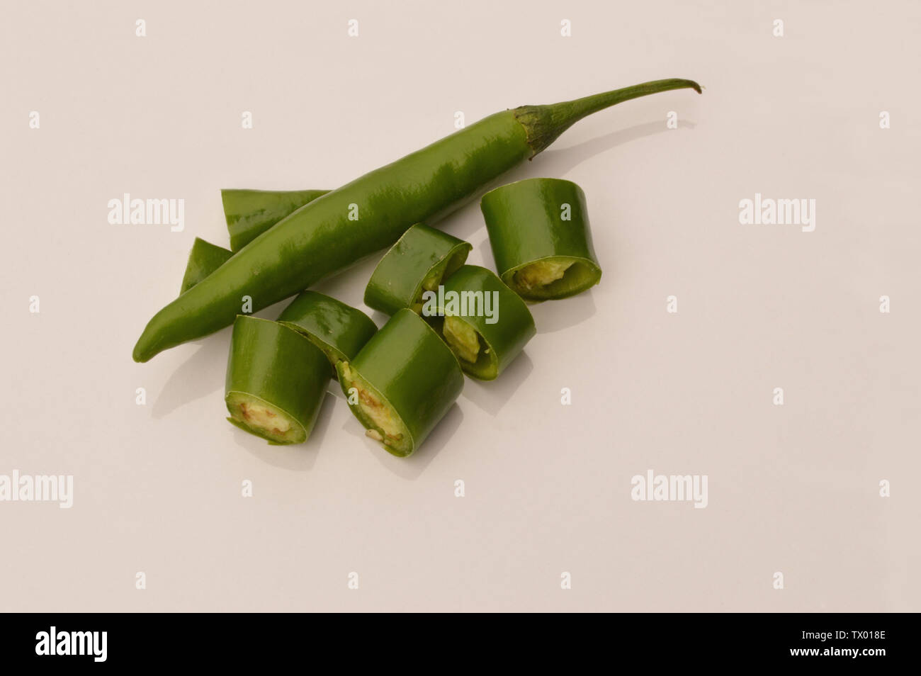 Fresh green chili, hot and spicy green fresh chili, whole and sliced
