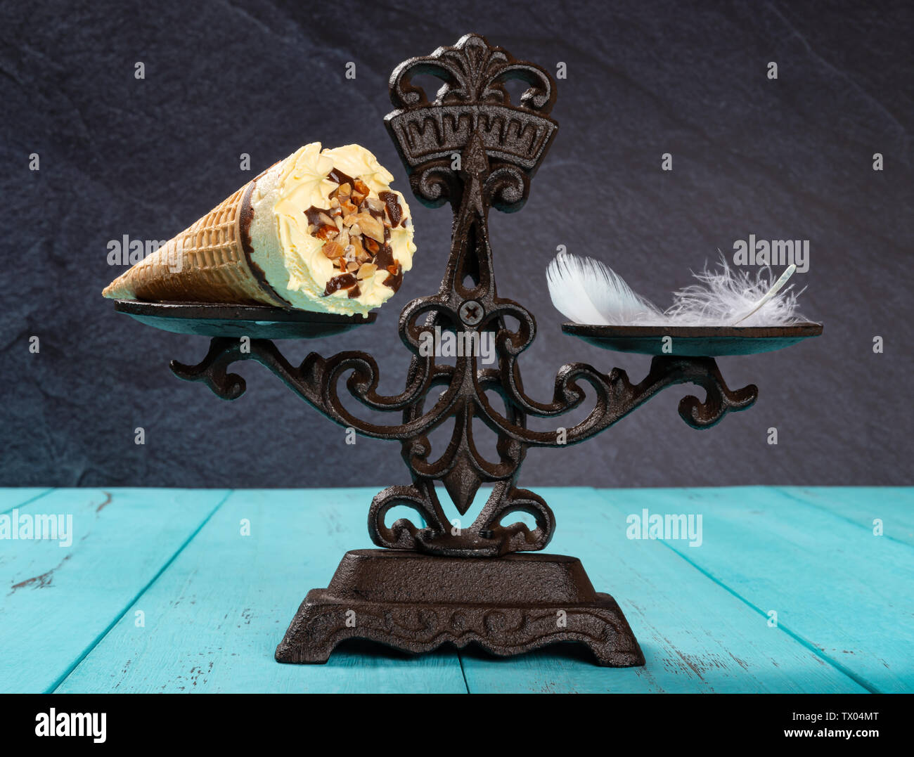ice cream cone and feather on a balanced scale concept of non fat ice