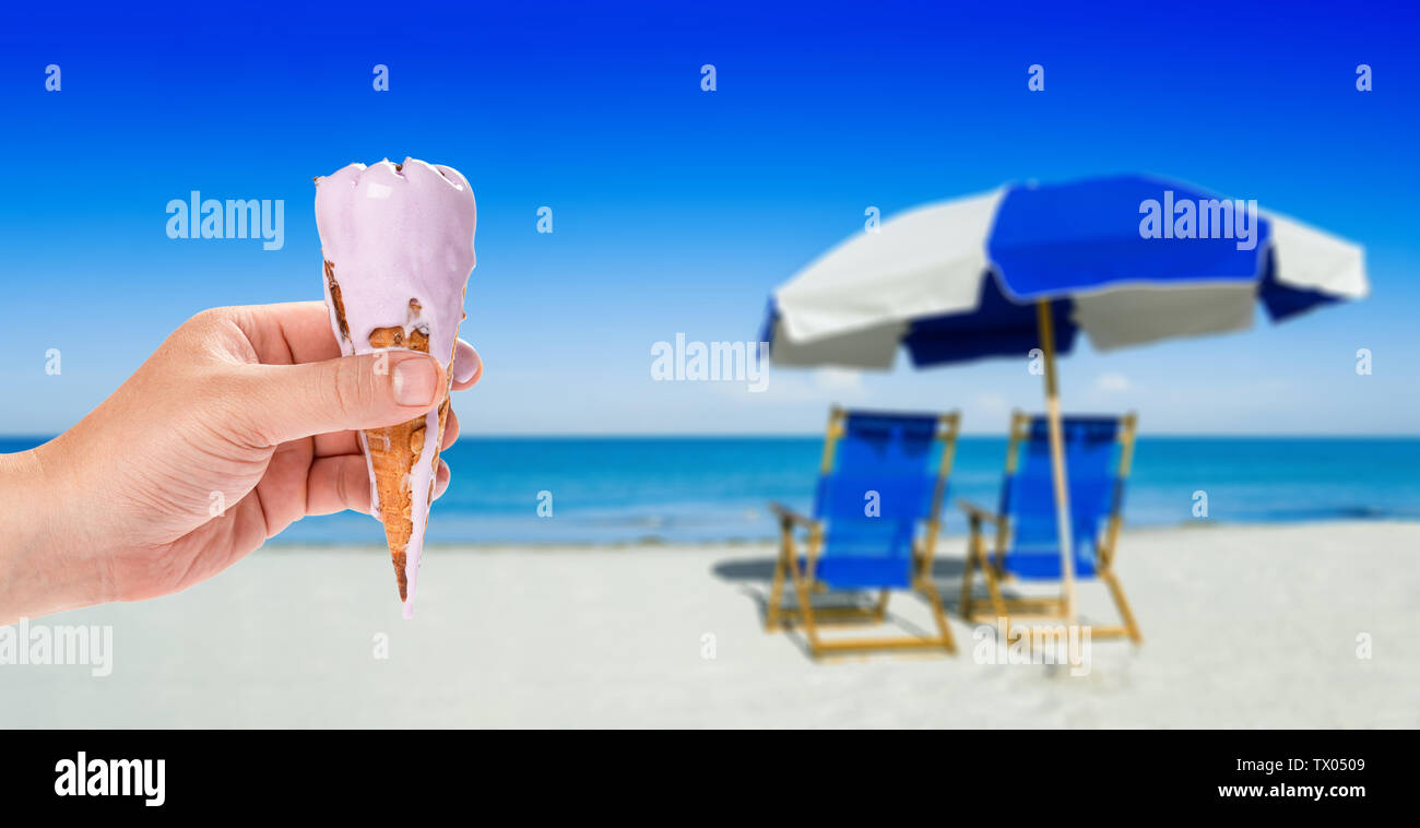 sun loungers and a beach umbrella on silver sand,  vacation concept Stock Photo