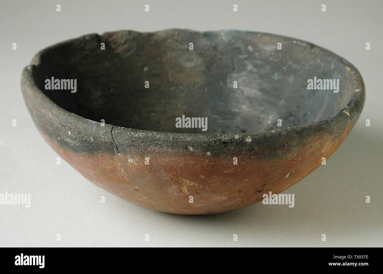 Black-topped Ware Bowl; Egypt, Predynastic Period (5500 - 3050 BCE)  Furnishings; Serviceware Terracotta Height:  1 15/16 in. (5 cm); Diameter:  4 1/2 in. (ll.4 cm) Gift of Jerome F. Snyder (M.80.202.40) Egyptian Art; Stock Photo