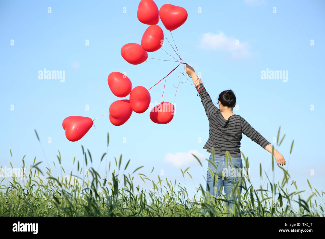 Girl holding red balloon Stock Photo Alamy
