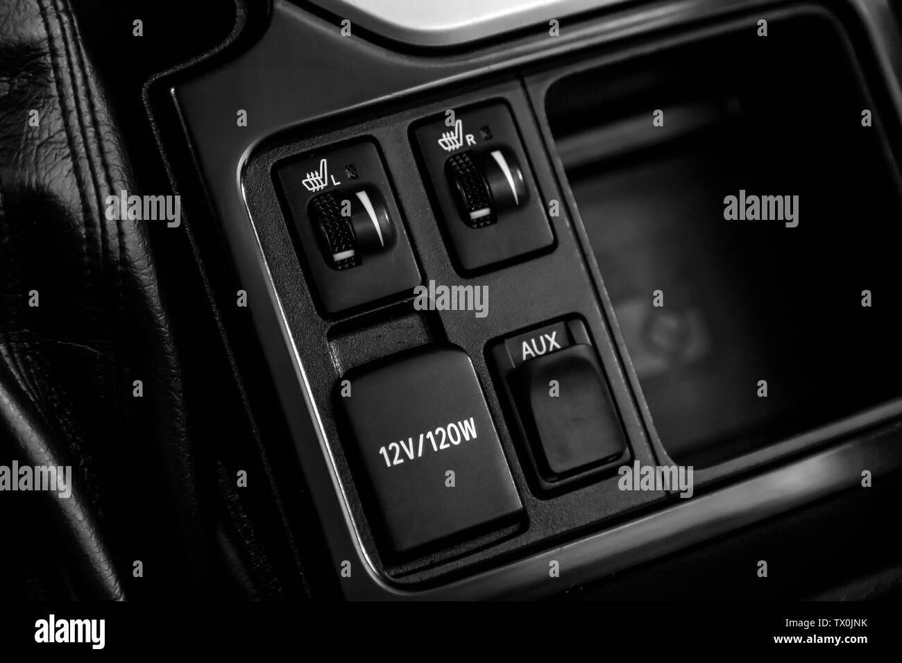 Close-up on the seat heatting buttons,    charging, aux . modern car interior: parts, buttons, knobs Stock Photo
