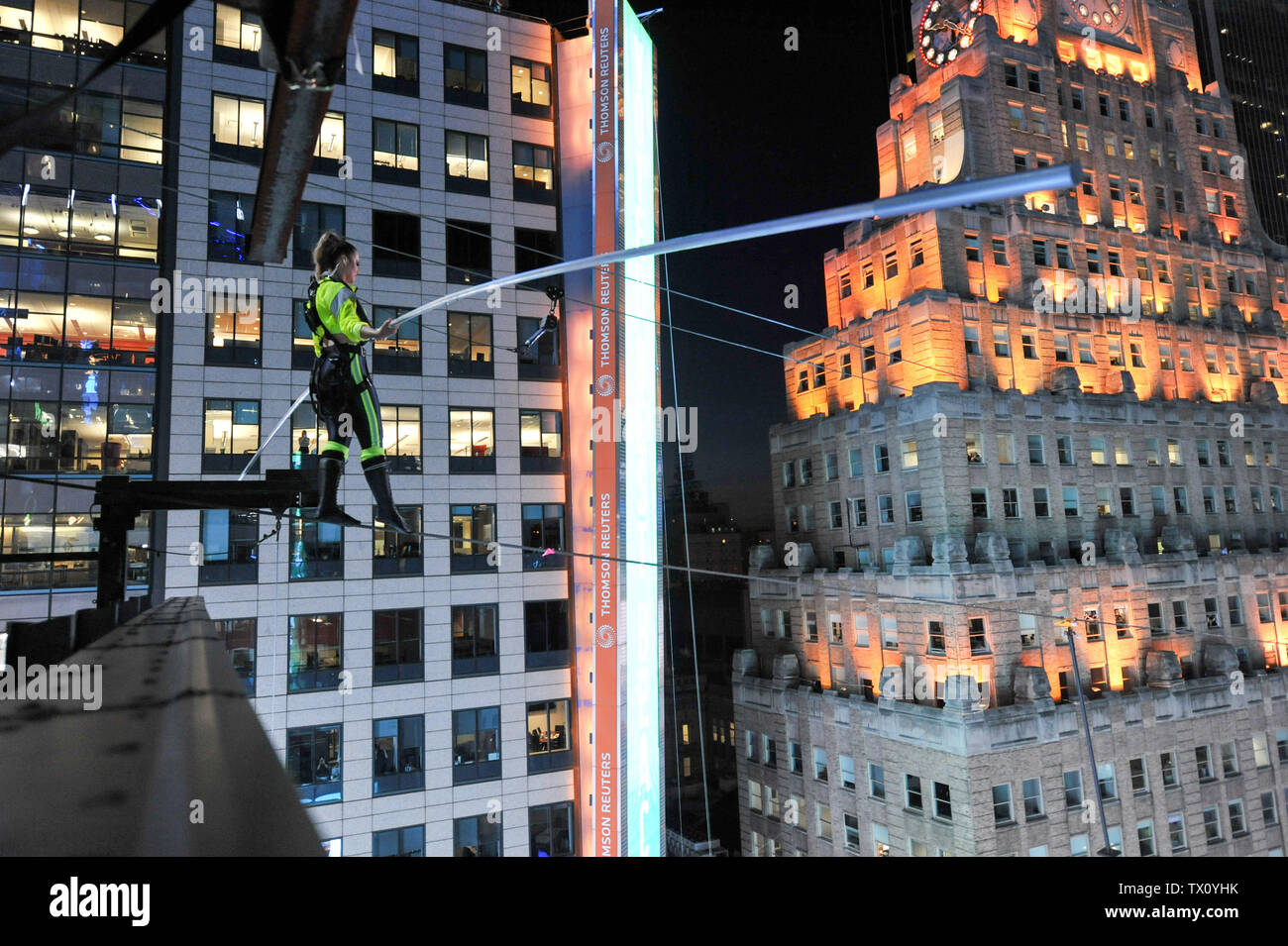 Nik and Lijana Wallenda walk a high wire across Times Square, New York