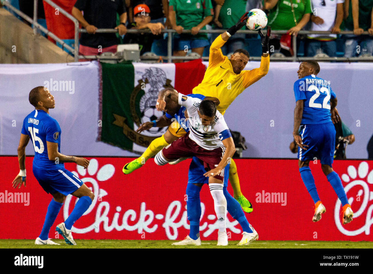 Charlotte, NC, USA. 23rd June, 2019. Martinique goalkeeper Loic Chauvet (1) grabs the ball over top of Mexico midfielder Andres Guardado (3) in the 2019 Gold Cup match at Bank of America Stadium in Charlotte, NC. (Scott Kinser) Credit: csm/Alamy Live News Stock Photo