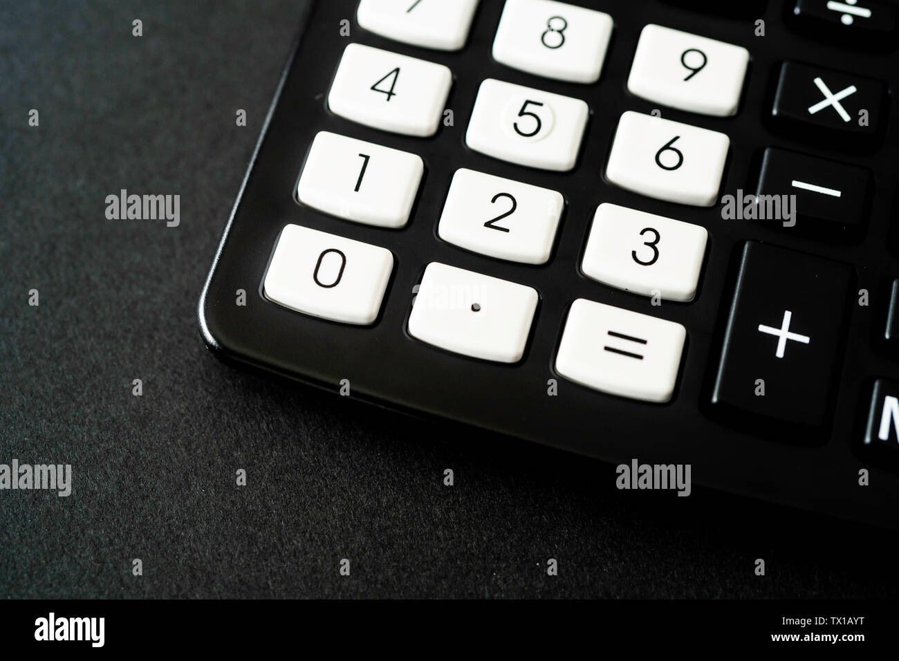 Black Pocket Calculator in office on black background Stock Photo