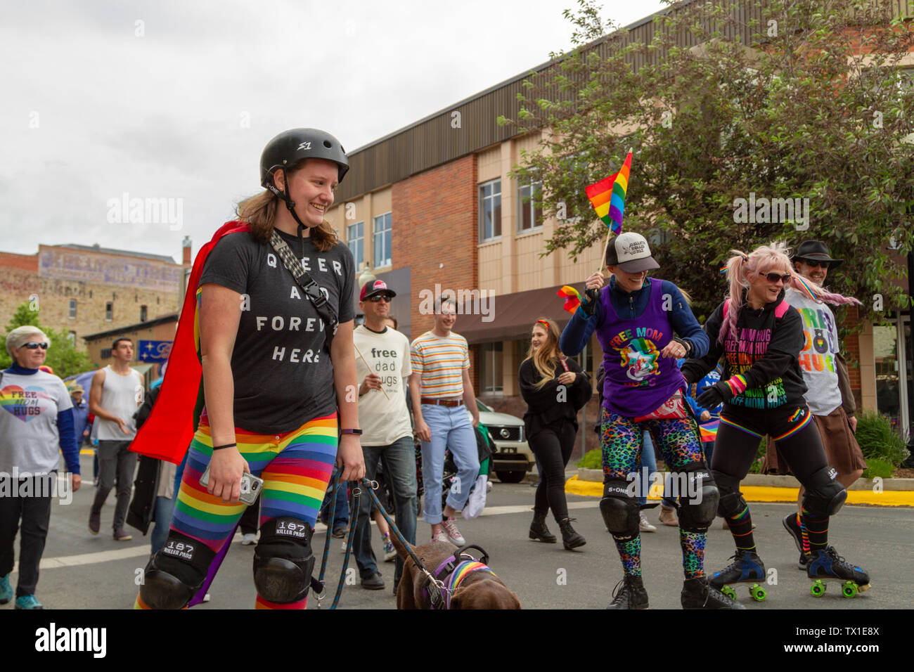 Young women roller skating in the 2019 Big Sky Pride Parade. Queer and