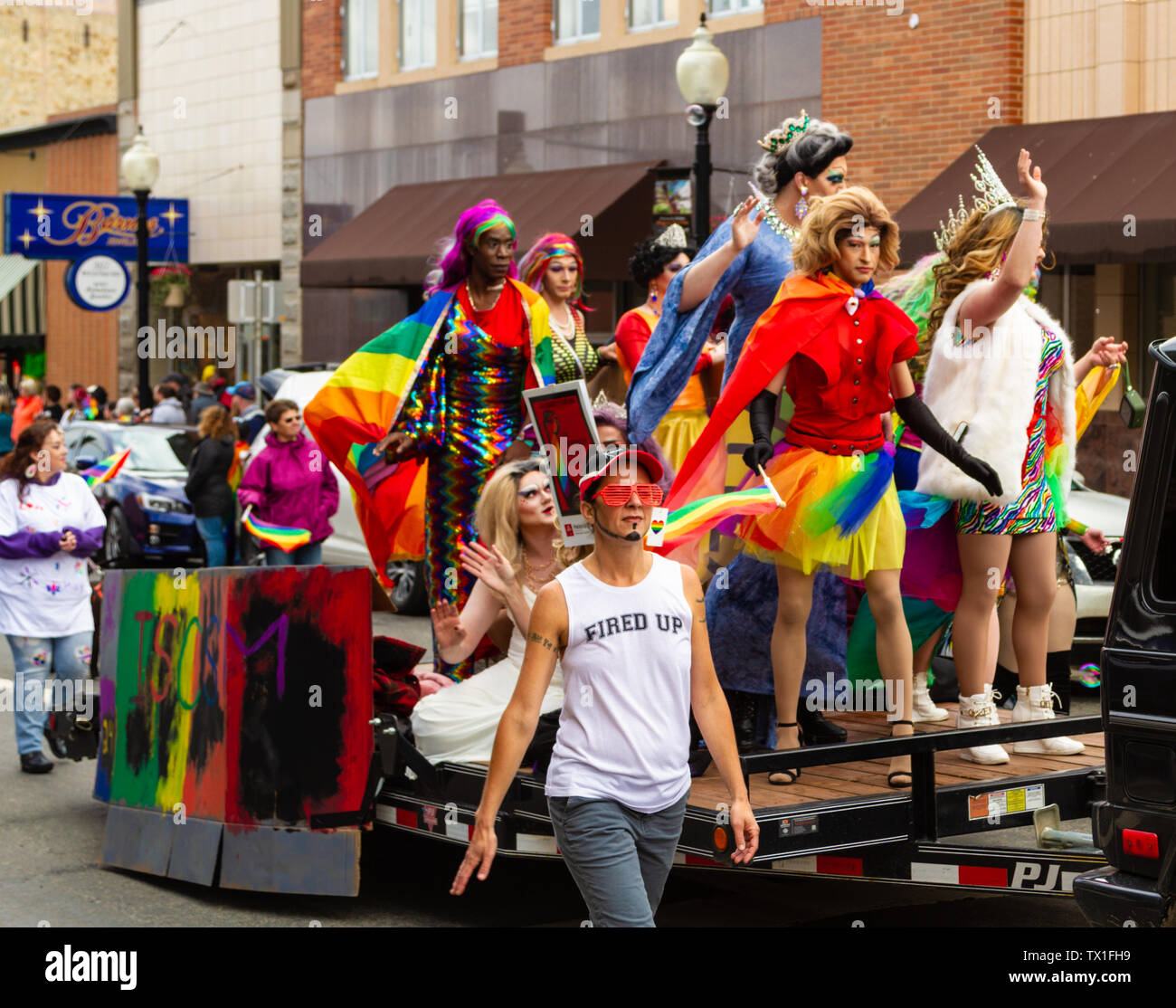 A float of drag queens wearing rainbow colors and showing their pride