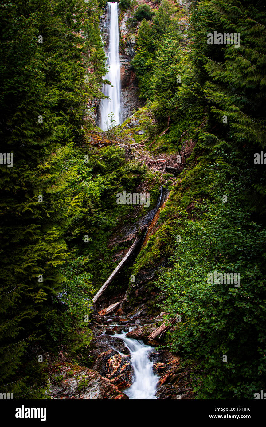 Long beautiful waterfall flowing along rocks Stock Photo