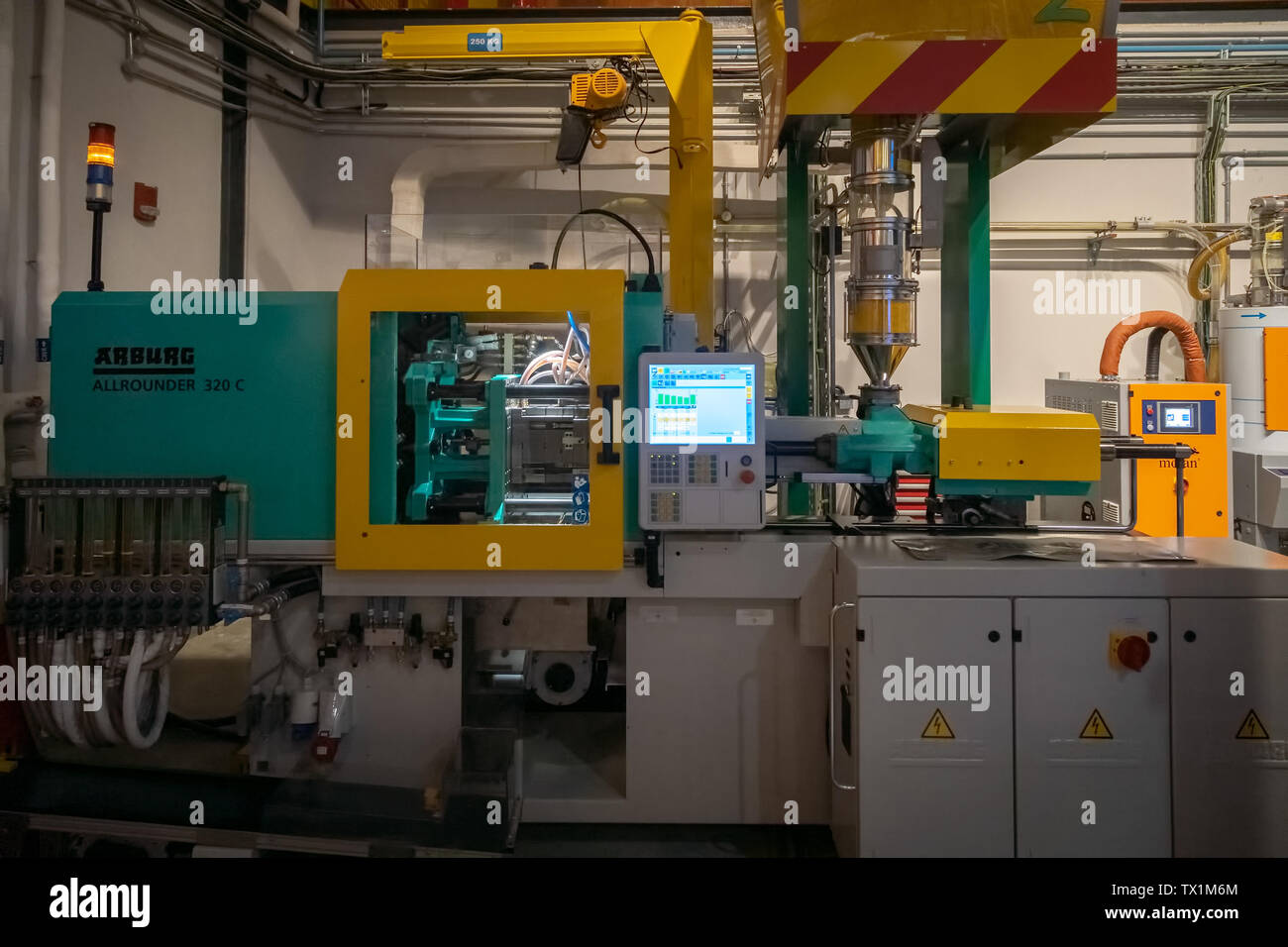 DUBAI, UAE, JANUARY 09, 2019: Plastic injection molding machine in the process of creating a brick Lego in Legoland Stock Photo