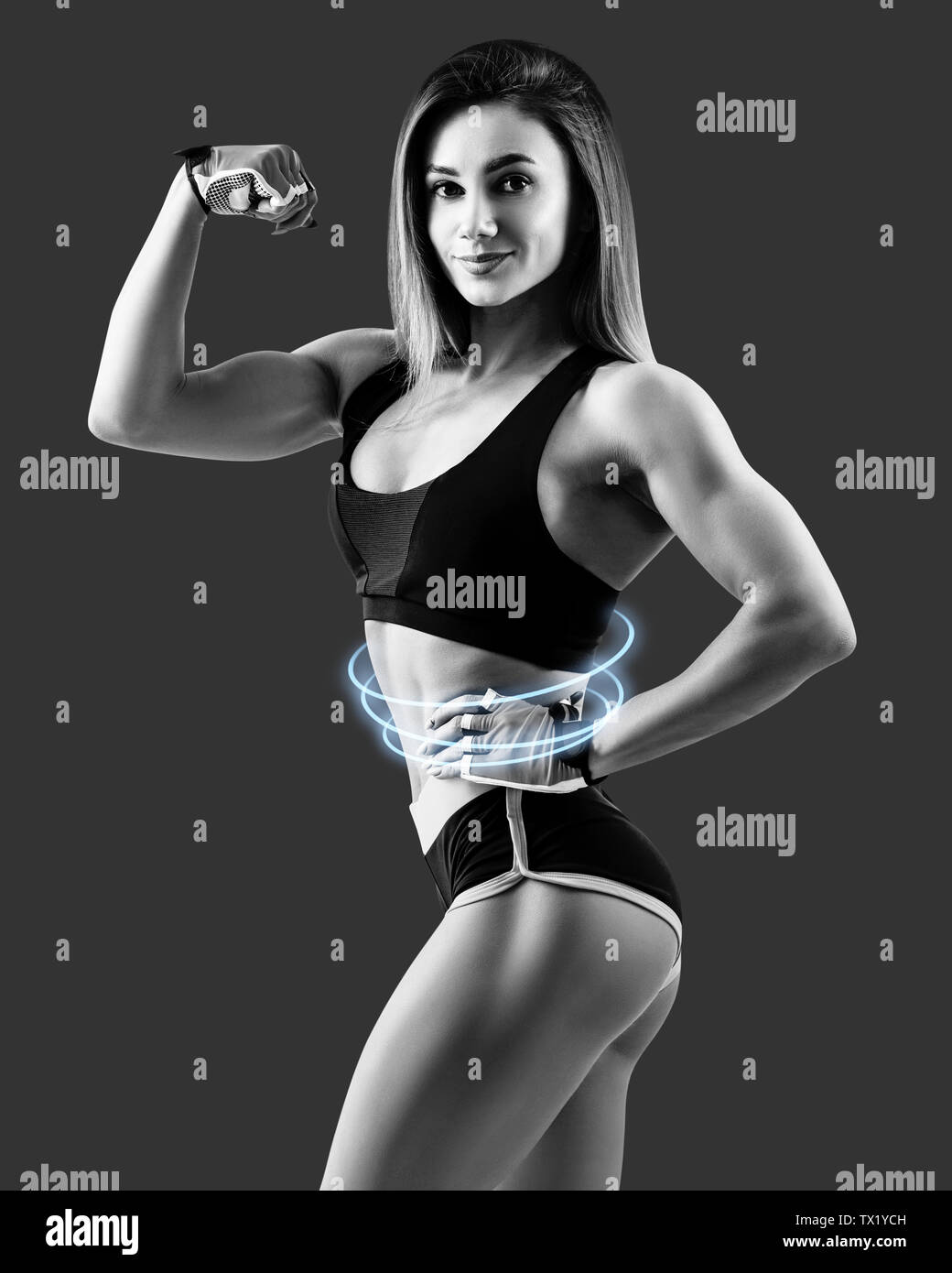 Young woman demonstrated her beautiful muscular athletic body. Stock Photo