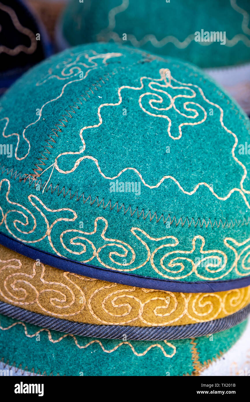 Kyrgyz headdress hats made of felt with a national ornament closeup. Market. Travel. Kyrgyzstan Stock Photo