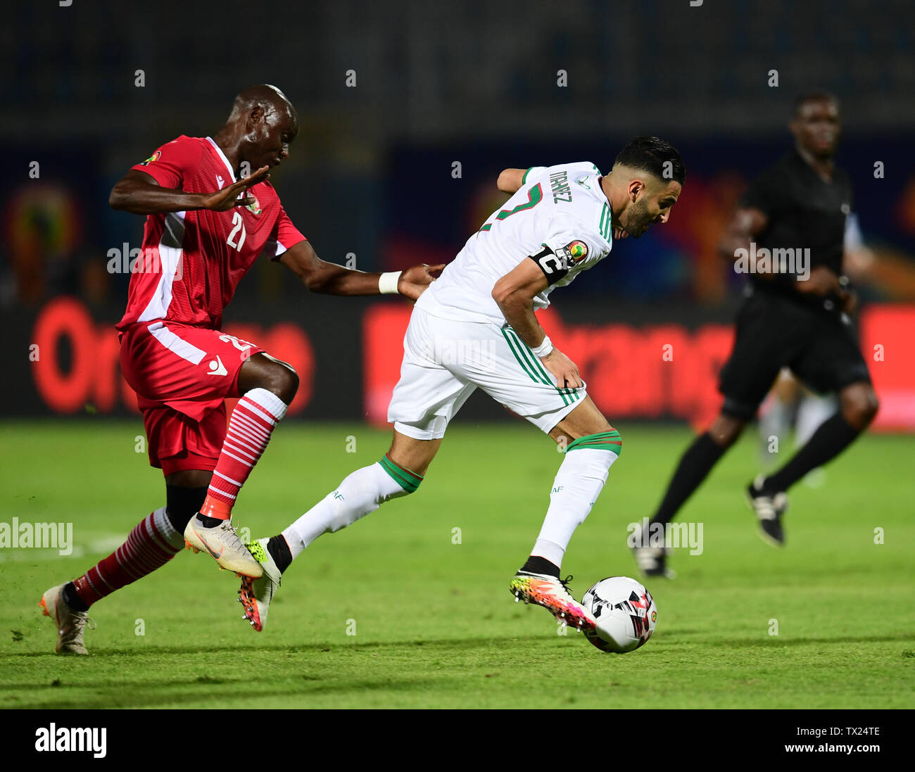 Cairo. 23rd June, 2019. Riyad Mahrez (R) of Algeria vies with Dennis Odhiambo of Kenya during the 2019 African Cup of Nations Group C match between Algeria and Kenya in Cario, Egypt on June 23, 2019. Algeria won 2-0. Credit: Wu Huiwo/Xinhua/Alamy Live News Stock Photo