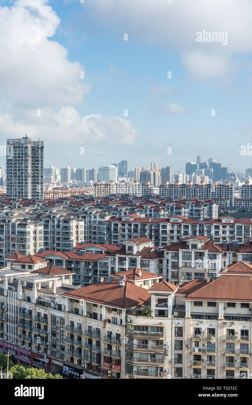 City buildings under blue sky and white clouds Stock Photo - Alamy