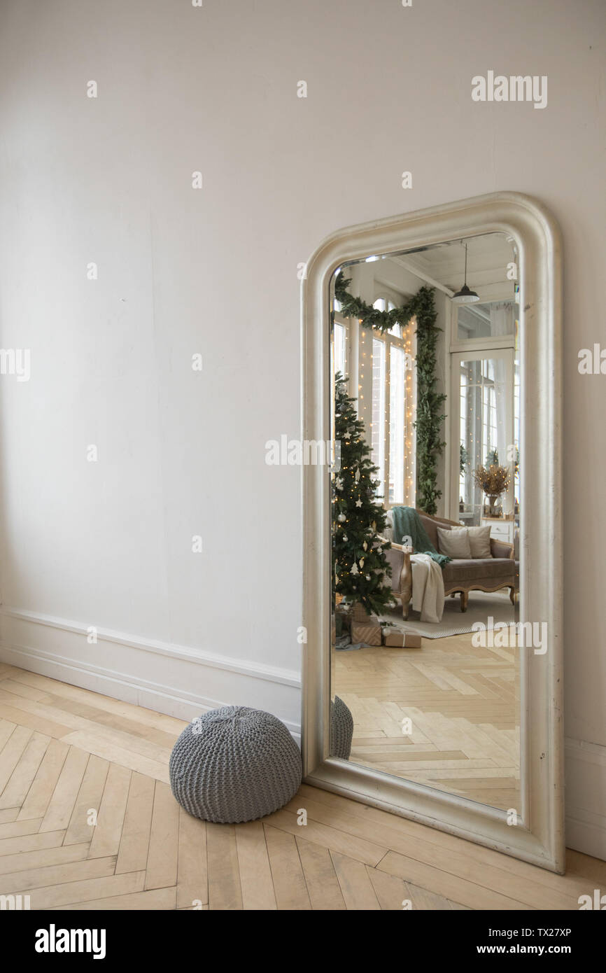 Mirror against wall reflecting interior of room Stock Photo