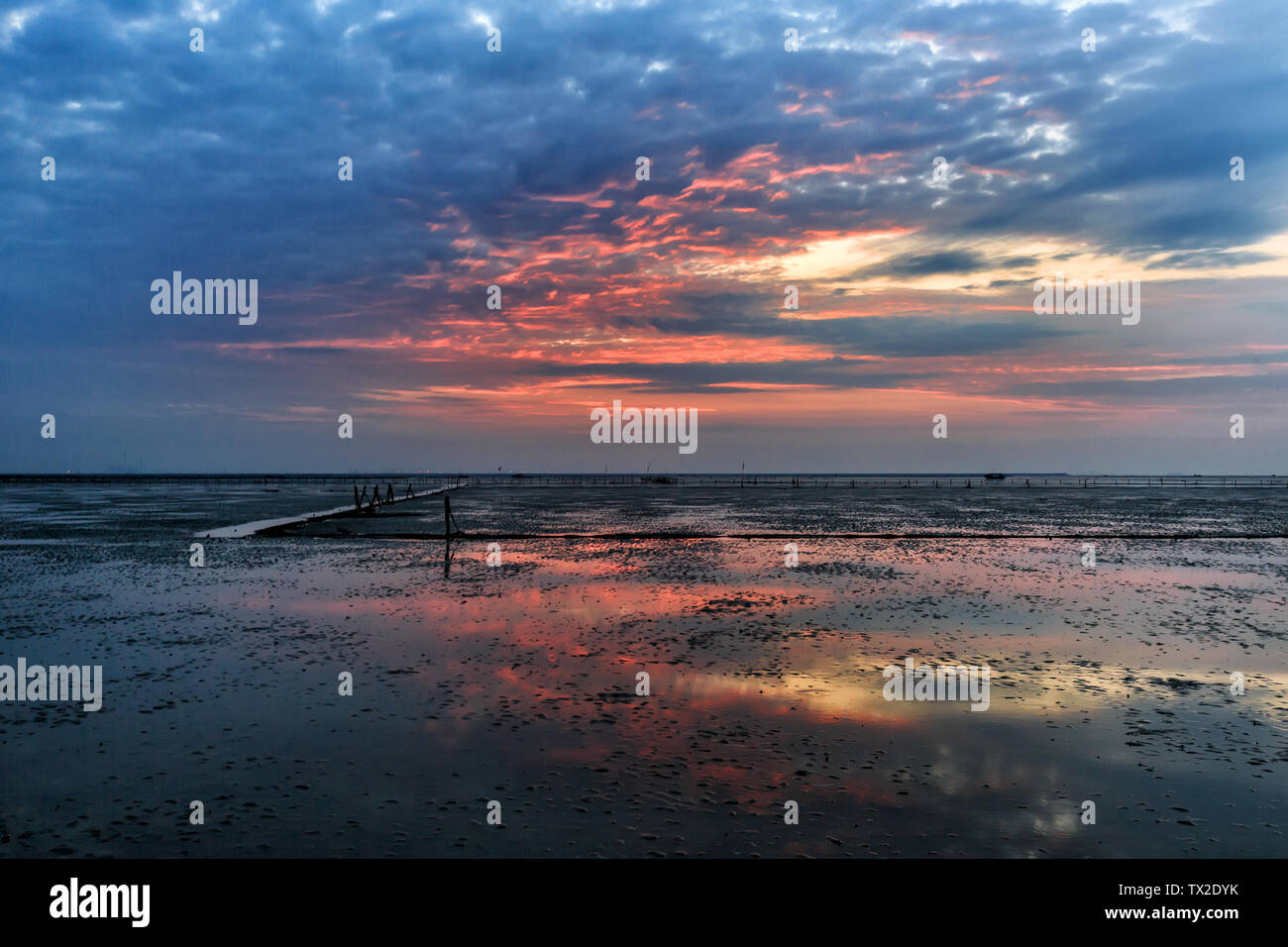 Beach, sea, early sunset, fishing boat, trestle Stock Photo - Alamy