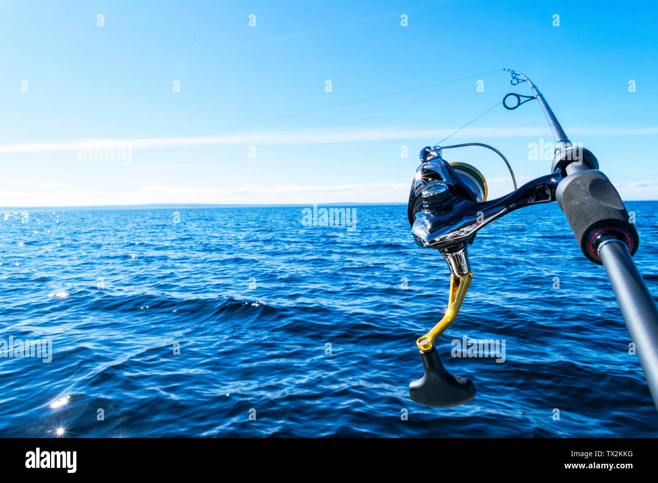 Fishing rod spinning with the line close-up. Fishing rod in rod holder in fishing  boat due the fishery day. Fishing rod rings. Fishing tackle. Fishing Stock  Photo - Alamy