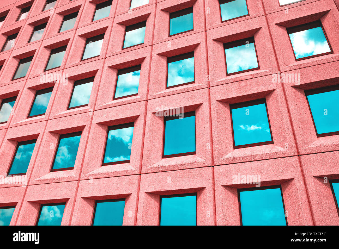 Regular pattern of windows in a colorful building Stock Photo