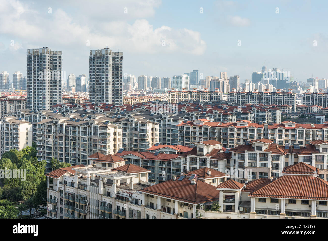City buildings under blue sky and white clouds Stock Photo - Alamy