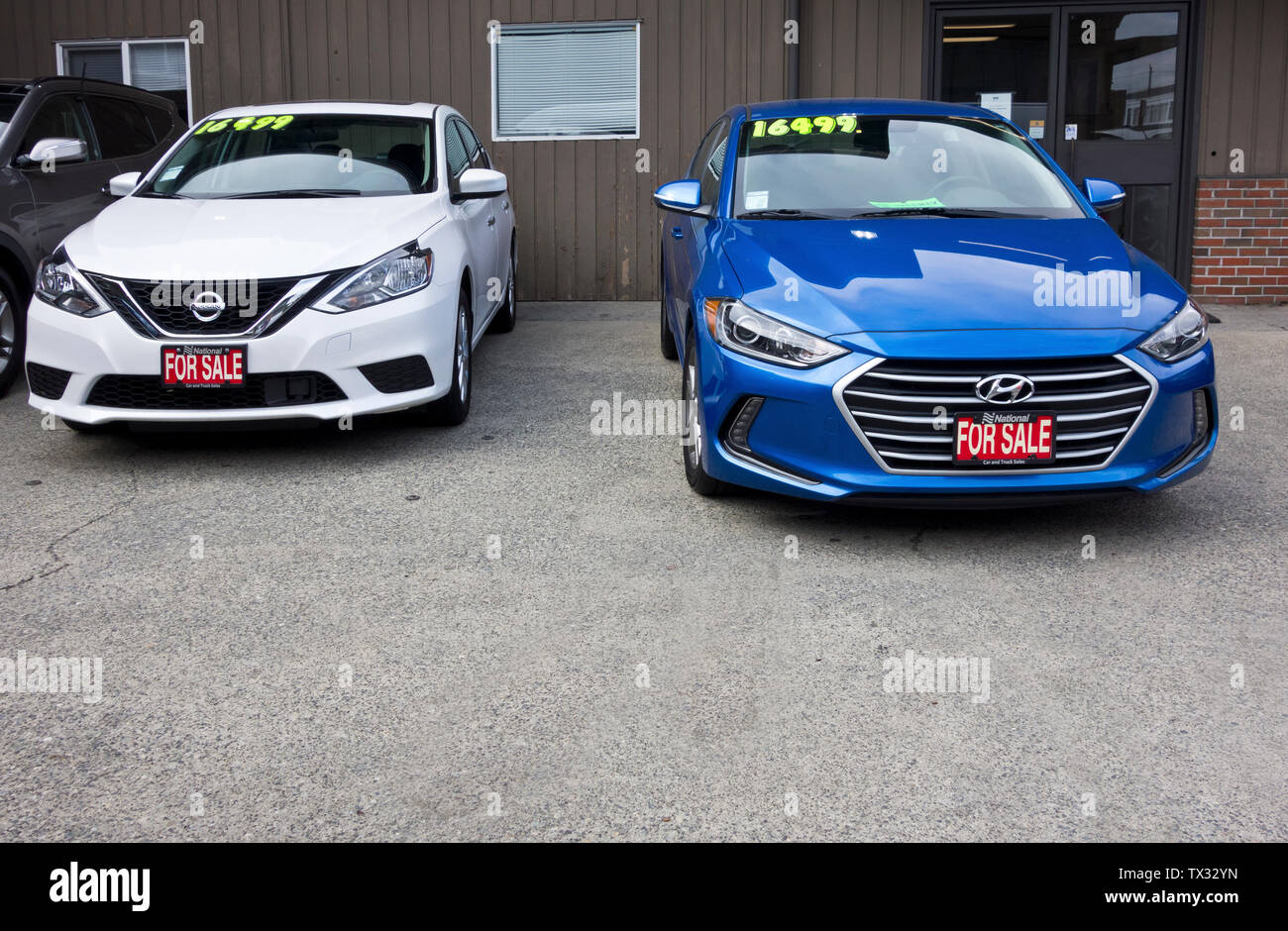 White 2018 Nissan Sentra and Blue 2018 Hyundai Elantra at a used car lot.  Previously owned cars for sale in  Vancouver. Stock Photo