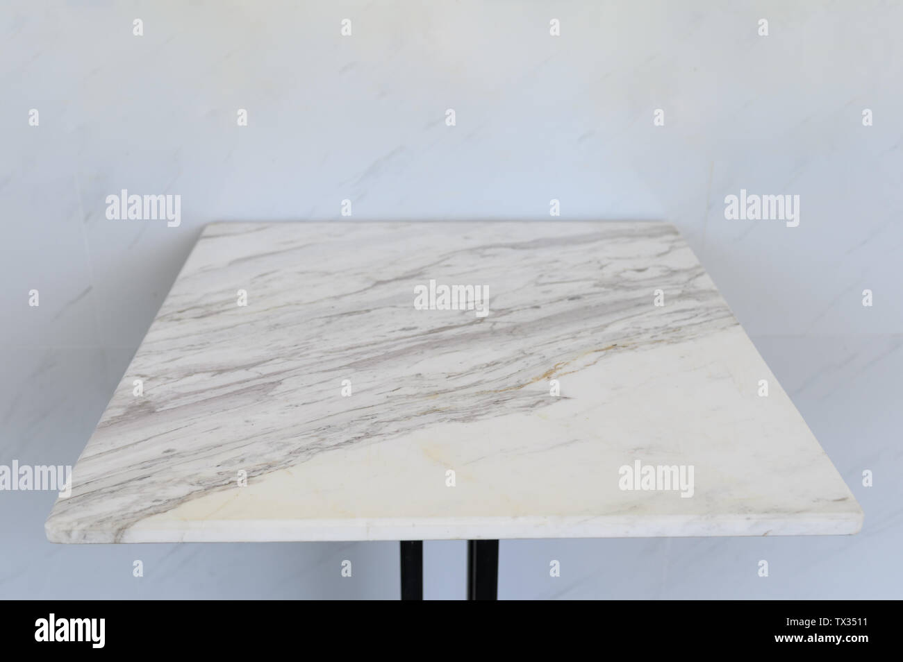 Tracery marble table adjoining on marble wall Stock Photo