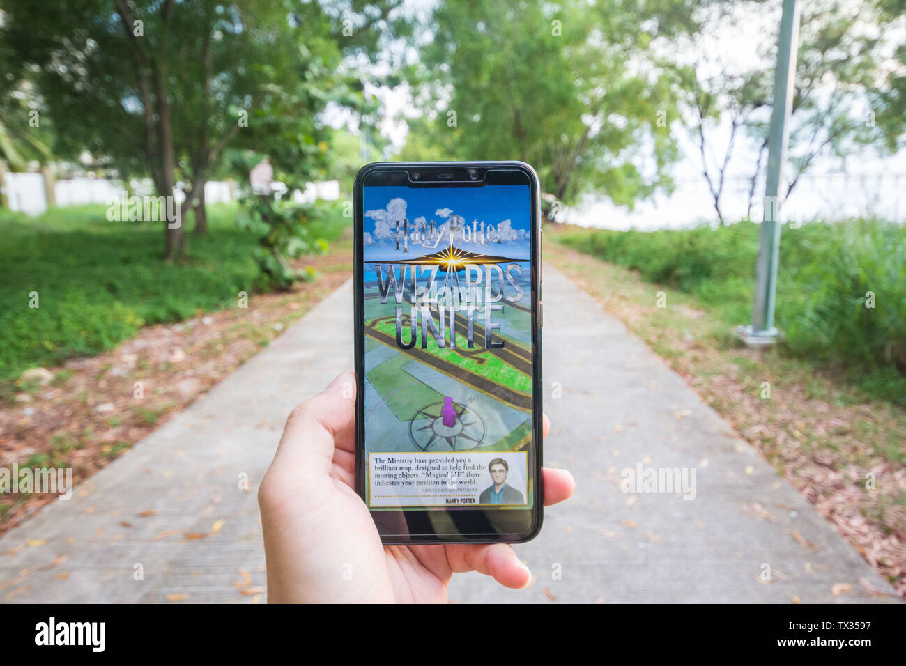 Kuala Lumpur Malaysia June 19 A Man Is Holding An Unbranded Phone Playing An Augmented Game By Niantic The Harry Potter Wizards Unite Stock Photo Alamy