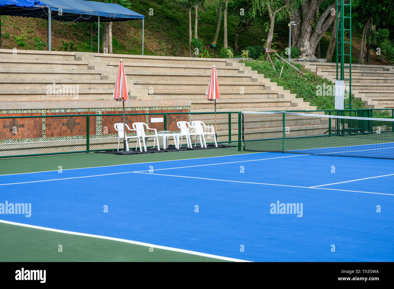 Synthetic Rubber Field In Tennis Court With Chairs And Parasols
