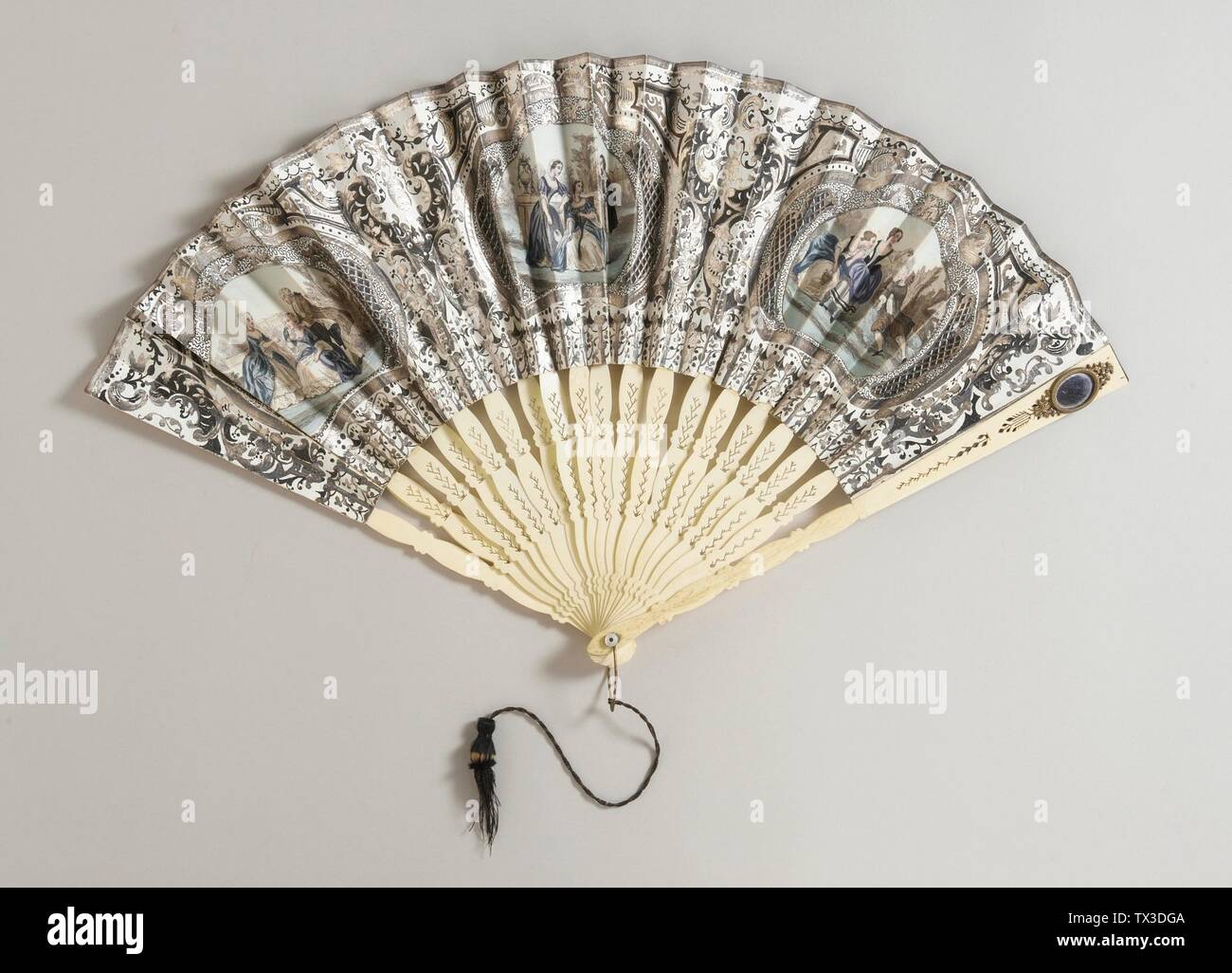 Folding Fan (image 1 of 2);  France, circa 1845 Costumes; Accessories Lithographed paper leaf, bone sticks, brass metallic loop and rivet, mother-of-pearl button, silk tassel Gift of Mrs. J. C. Fjerdingstad (33.30.19) Costume and Textiles; circa 1845 date QS:P571,+1845-00-00T00:00:00Z/9,P1480,Q5727902; Stock Photo