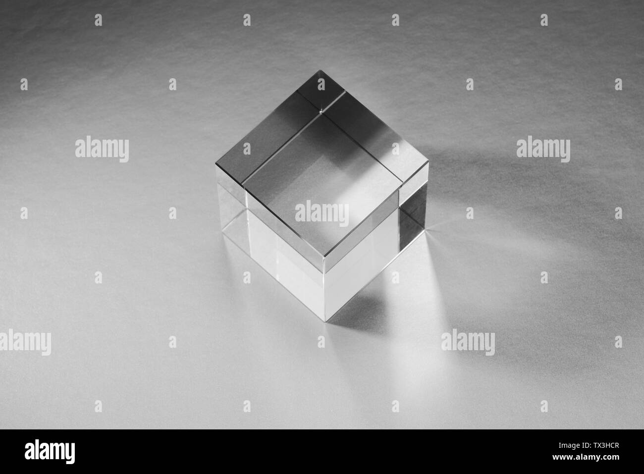 Clear, artificial resin cube reflecting light Stock Photo