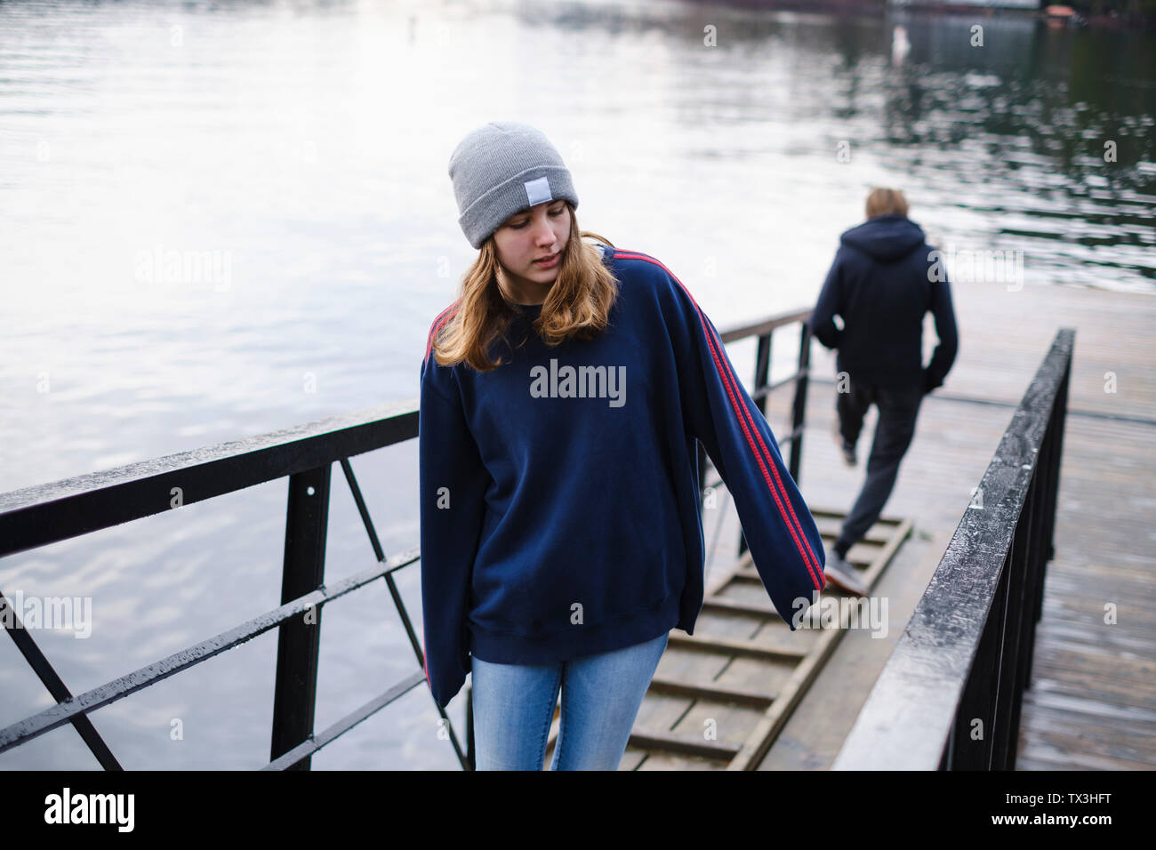 Teenage girl walking up ramp over Shawnigan Lake, British Columbia ...