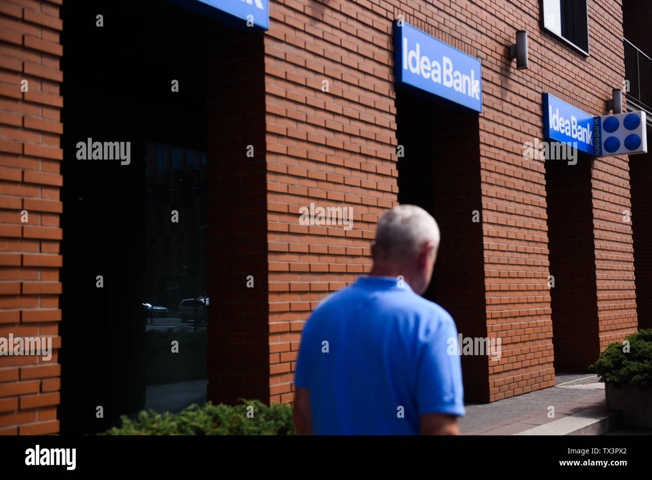 Krakow, Poland. 21st June, 2019. A man walks by Idea Bank branch in the city center. Polish based Idea bank last week informed that it would fire up to 750 staff during the next six months, due to a loss of 1.9bn zloty from last year. Credit: SOPA Images Limited/Alamy Live News Stock Photo