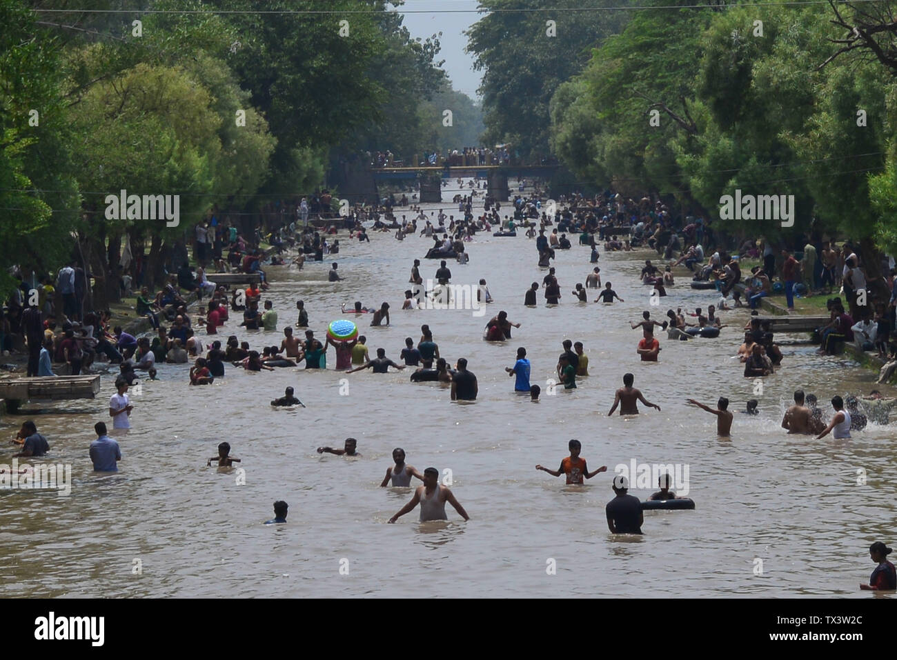 Children swim in a canal to cool off as temperature reached 44 C (112 F) in  Lahore, Pakistan, Sunday, May 15, 2022. (AP Photo/K.M. Chaudary Stock Photo  - Alamy