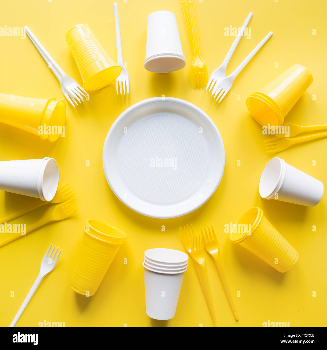Disposable picnic utensils for recycling on yellow. Environment eco friendly discarded plastic garbage collection for recycle concept.Top view. Flat l Stock Photo