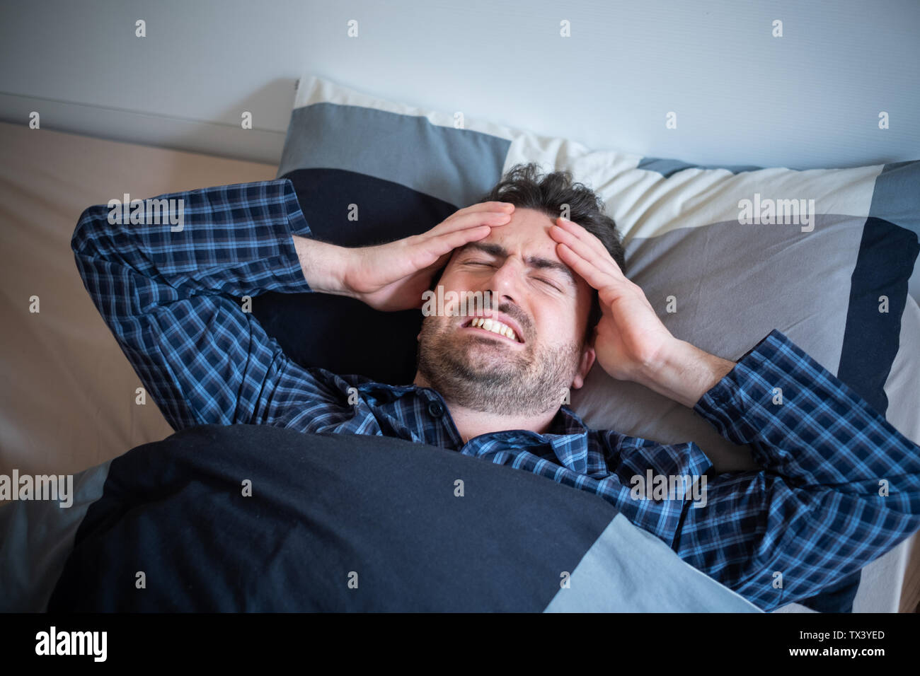 Man is feeling headache and can't sleep Stock Photo Alamy