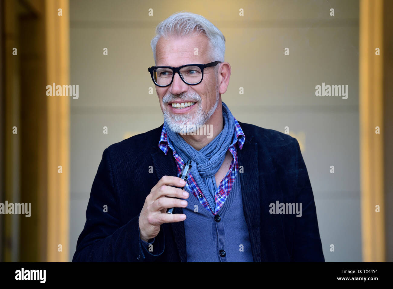 Portrait of a mature man, smoking electronic cigarette Stock Photo