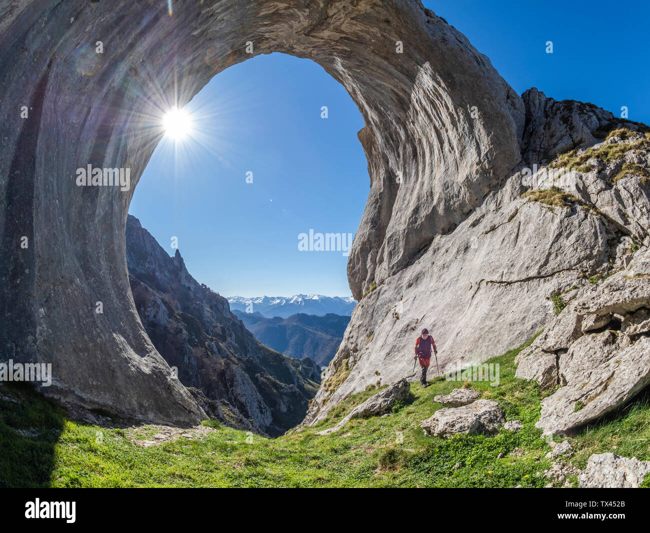 Spain, Asturia, Pena Mea, Ojo de buey, hiker against the sun Stock Photo