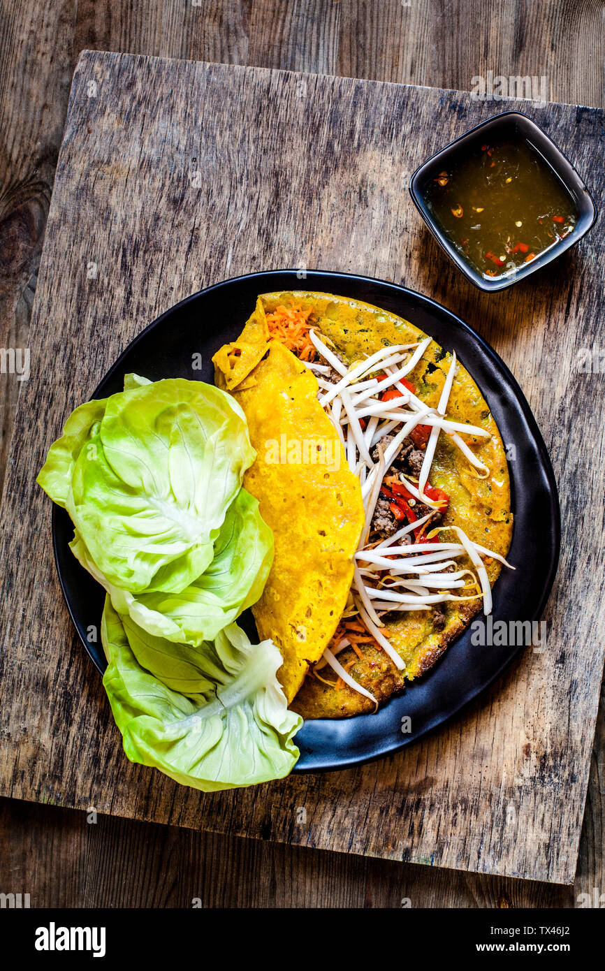 Banh xeo with lettuce and Nuoc Cham dipping sauce Stock Photo