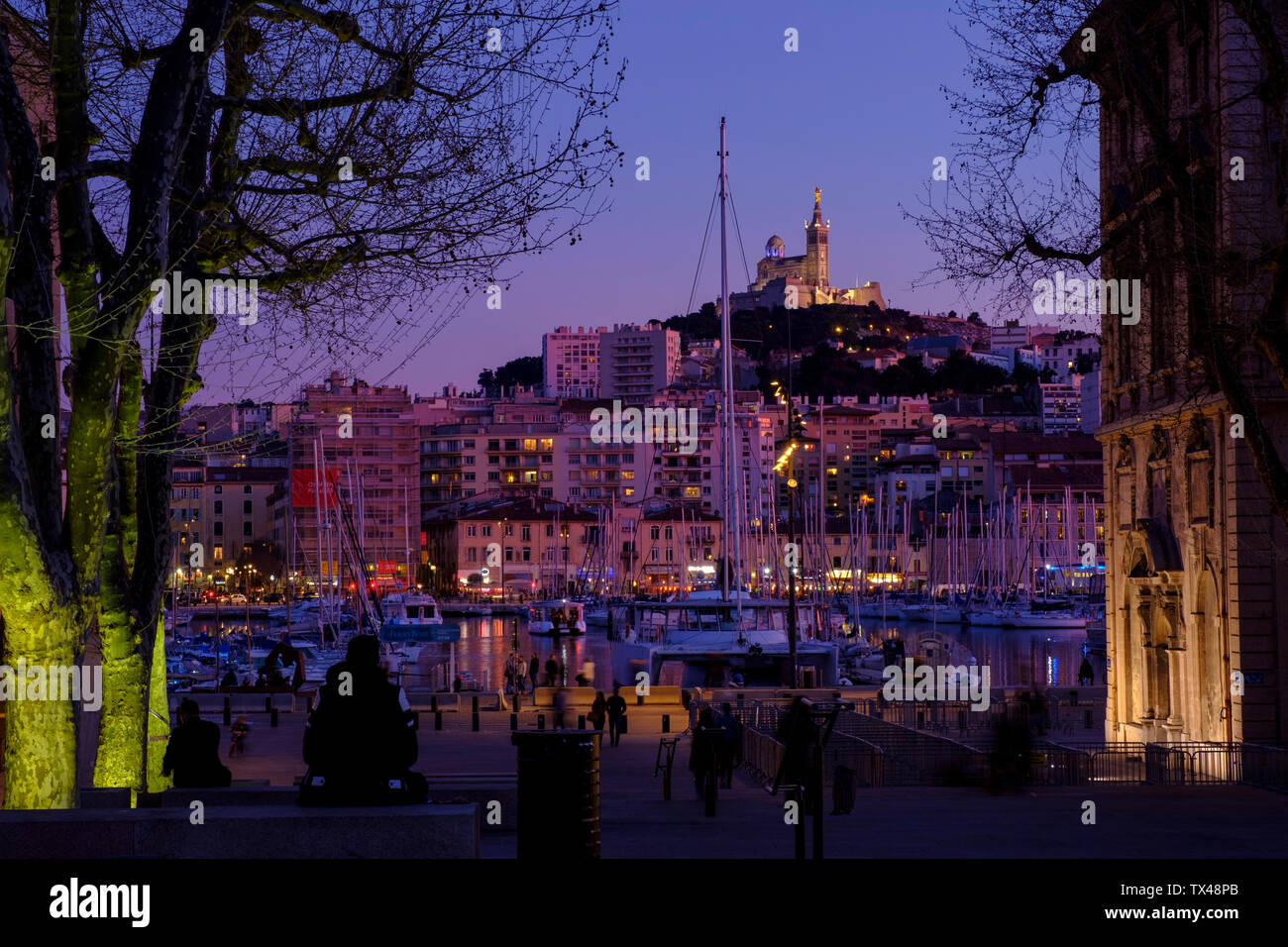 France, Marseille, old town, old harbour and Notre Dame de la Garde at dusk Stock Photo