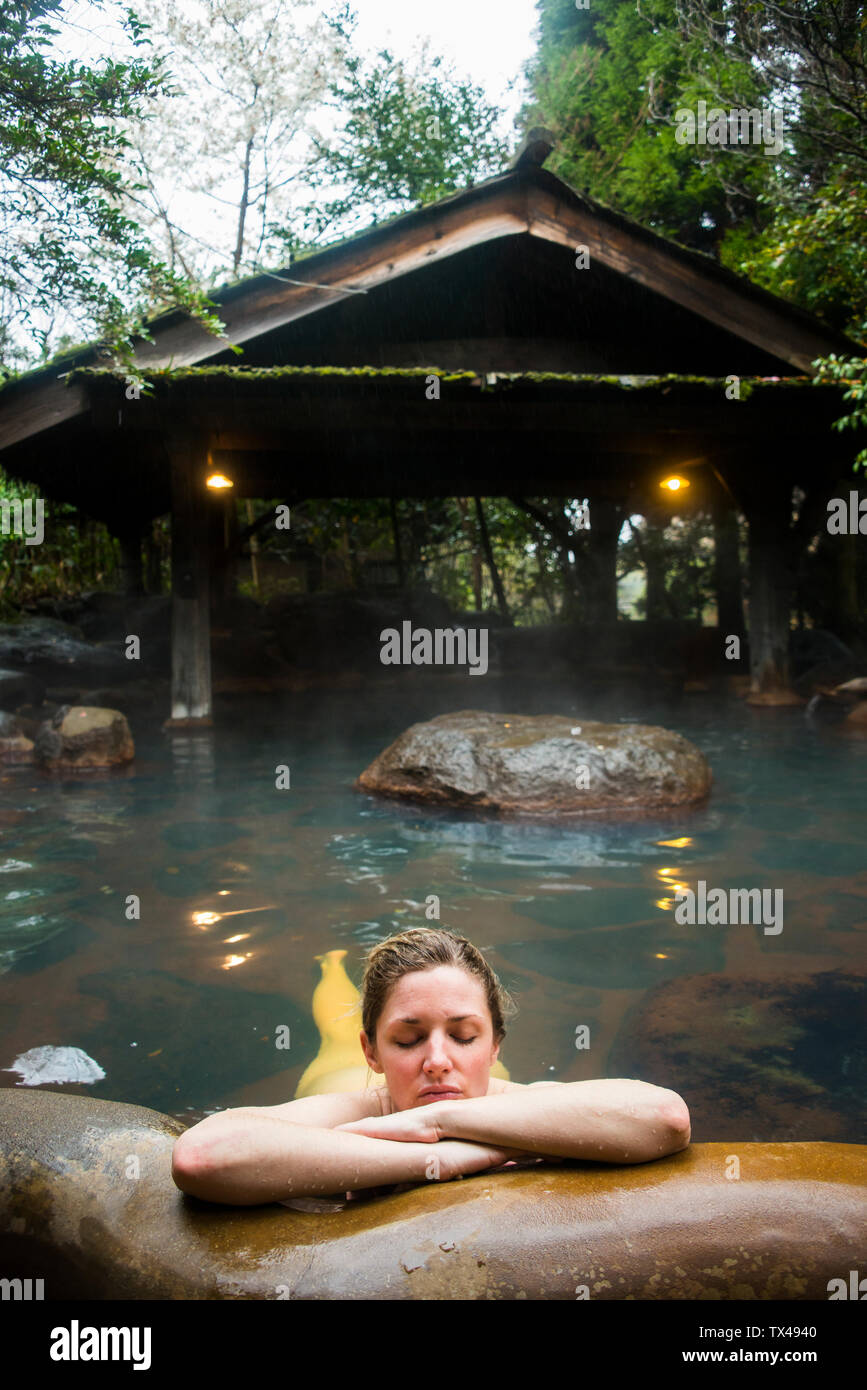 Japan, Kyushu, woman enjoying hot springs Stock Photo