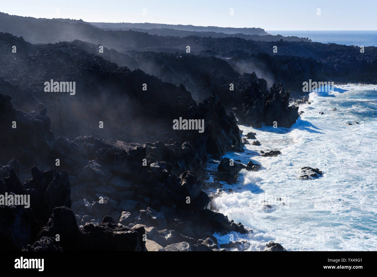 Spain, Canary Islands, Lanzarote, Tinajo, Los Volcanos nature park, sea foam at rocky coast Stock Photo