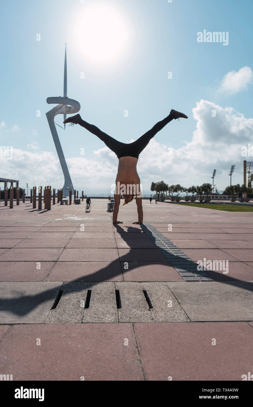 Young man doing a handstand in backlight Stock Photo