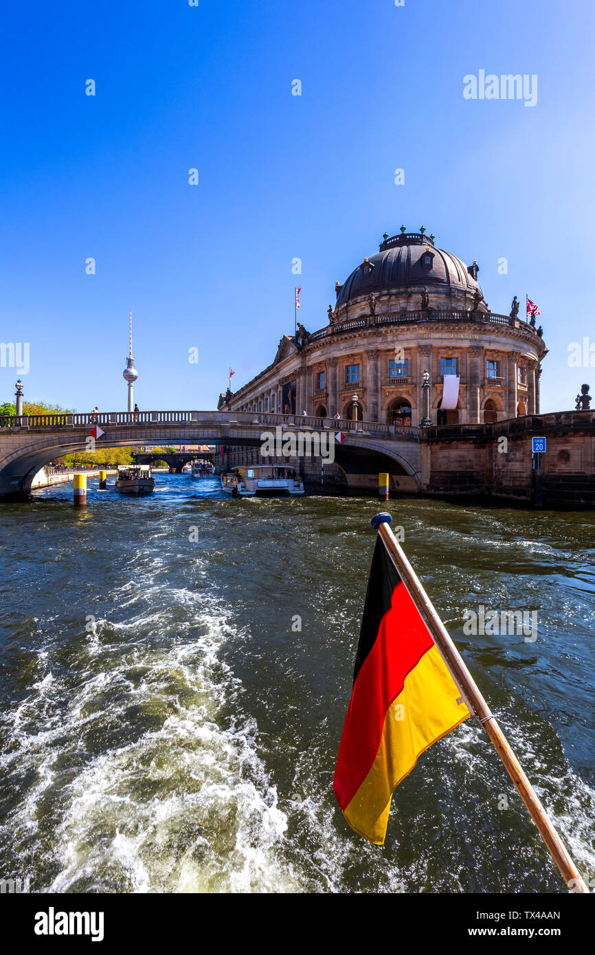 Germany, Berlin, Bode Museum and German flag on excursion boat on River Spree Stock Photo