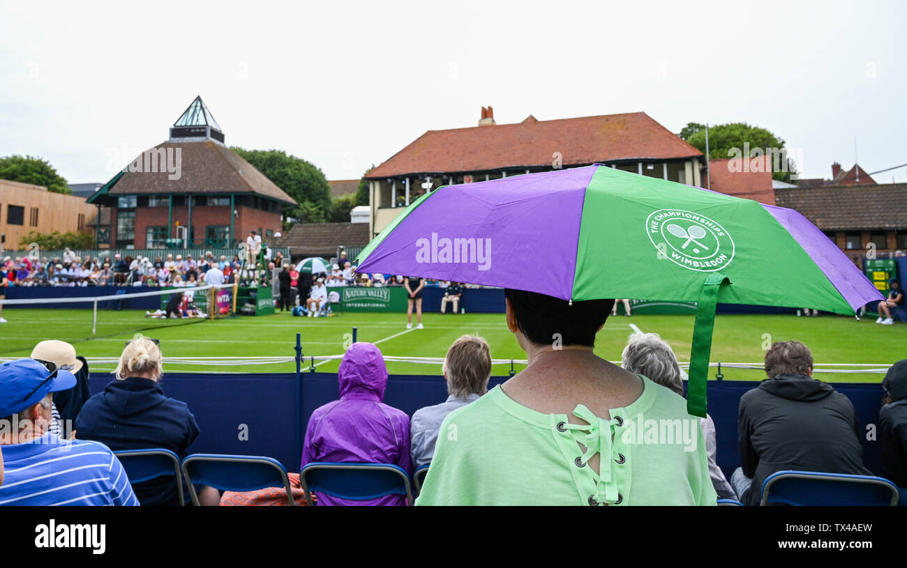 Eastbourne UK 24th June 2019 - The umbrellas come out as rain interrupts play during the Nature Valley International tennis tournament at Devonshire Park in Eastbourne . The forecast is for a heatwave along with thunder storms to arrive in Britain from mainland Europe with temperatures expected to reach the 30s in some parts of the south east. Credit : Simon Dack /TPI / Alamy Live News Stock Photo