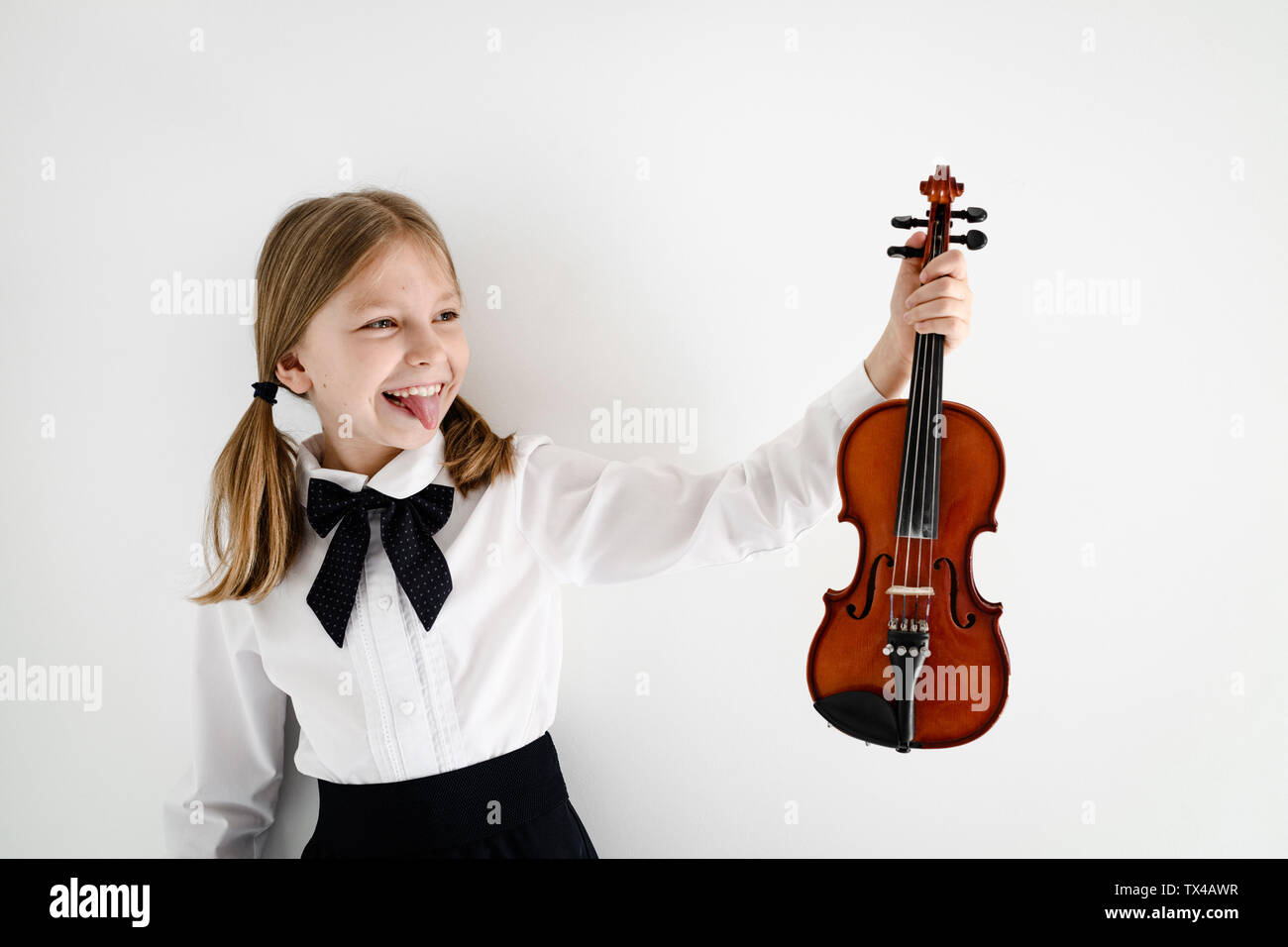 Funny girl holding a violin Stock Photo