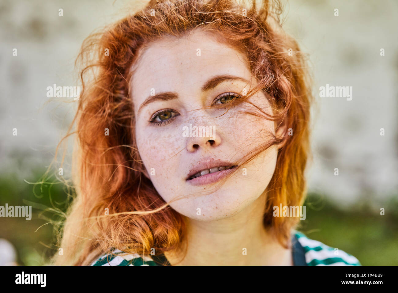 Portrait of redheaded young woman with freckles Stock Photo