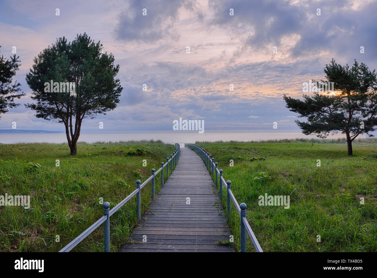 Germany, Ruegen Island, Binz, wooden boardwalk to beach in the evening Stock Photo