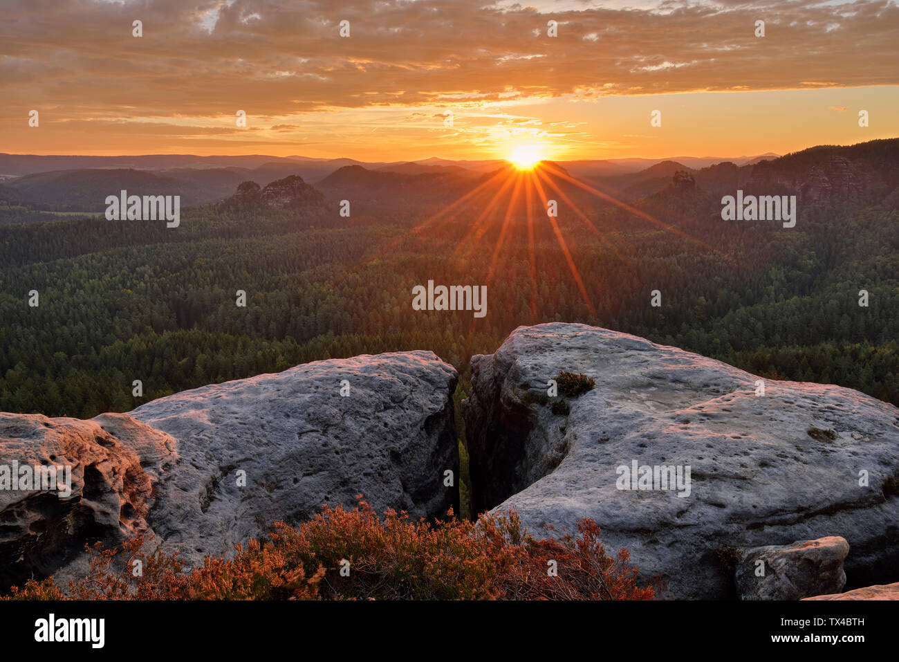 Germany, Saxony, Elbe Sandstone Mountains, view to the mountain Winterstein from the Gleitmannshorn at sunrise Stock Photo
