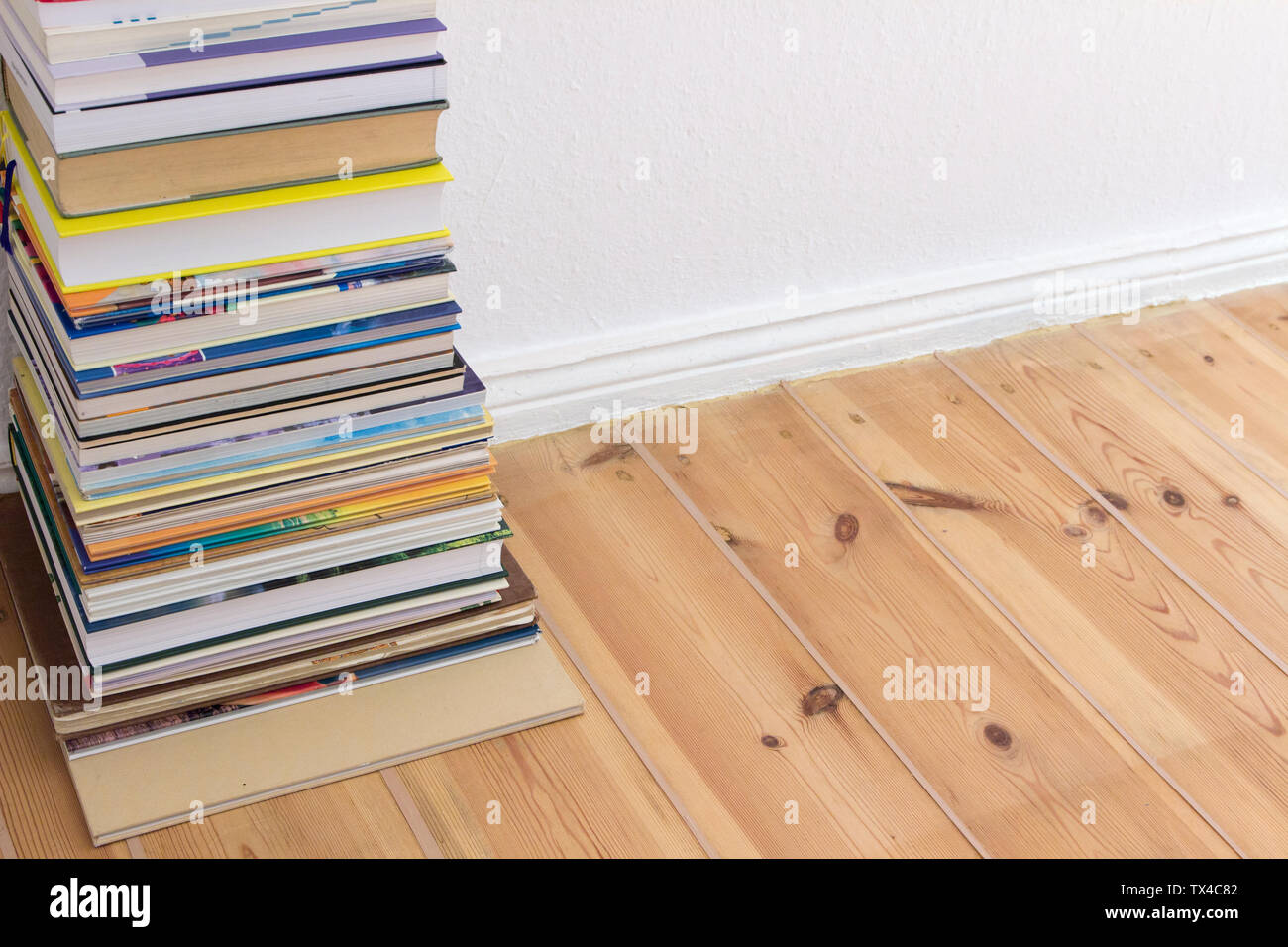 Stack of books on floor Stock Photo Alamy
