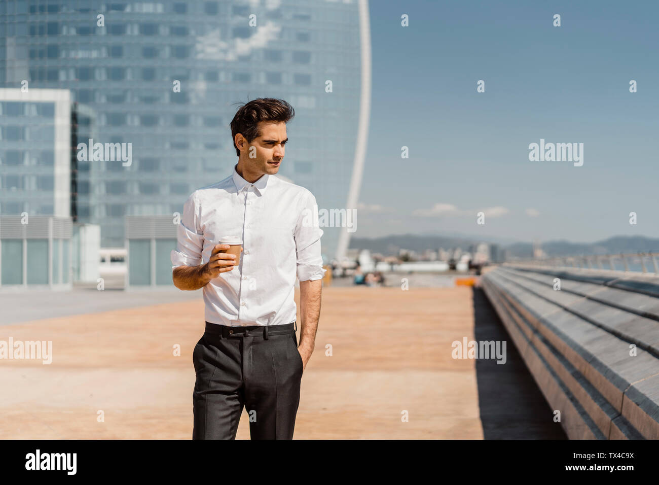 Businessman with takeaway coffee in the city Stock Photo