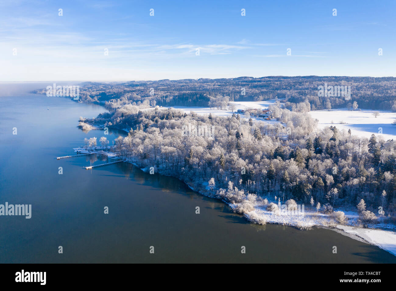 Germany, Bavaria, Sankt Heinrich, snowy forest at Lake Starnberg, aerial view Stock Photo